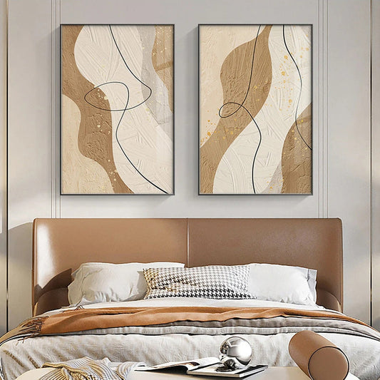 Two abstract wall art pieces above a bed with a brown headboard.