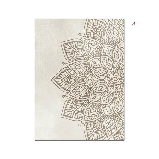 Two beige and brown mandala canvas prints hanging on a wall above a beige sofa with decorative cushions, with a plant and a glass of water on the table in the foreground.