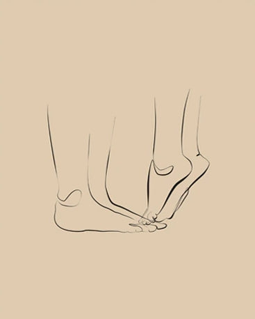 A canvas print of minimalist couple line art in black and white, displayed in a wooden frame, accompanied by white flowers in a vase.