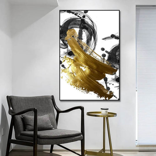 A modern abstract gold and black canvas wall art featuring flowing geometric shapes, displayed in a room with minimalist decor.