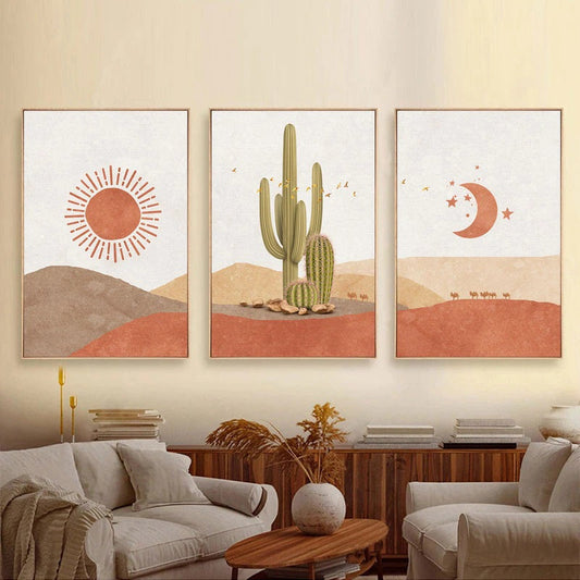A set of three minimalist landscape canvas prints depicting abstract natural scenes with geometric shapes, displayed above a grey sofa in a living room setting.