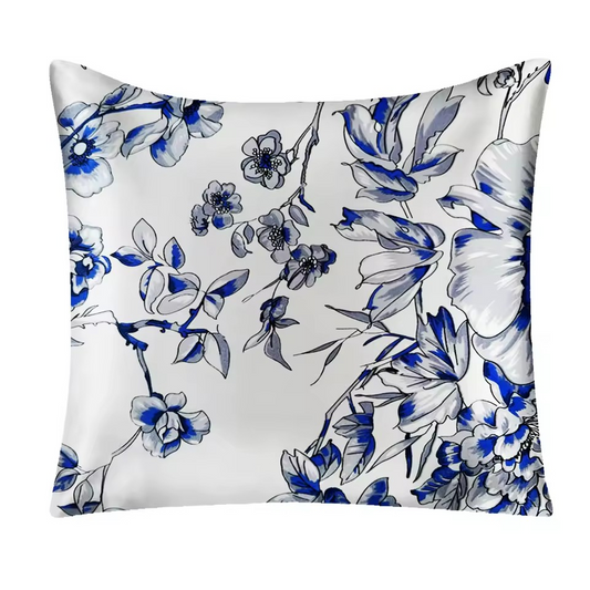 Floral pillow with blue and gray flowers on a white background