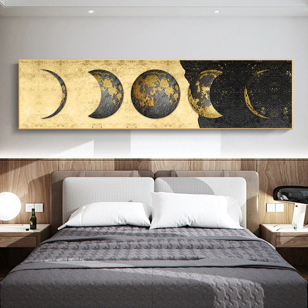 A canvas print featuring golden moon phases showing eight lunar cycles in gold tones in a slim format displayed above a grey sofa in a modern living room setting. 