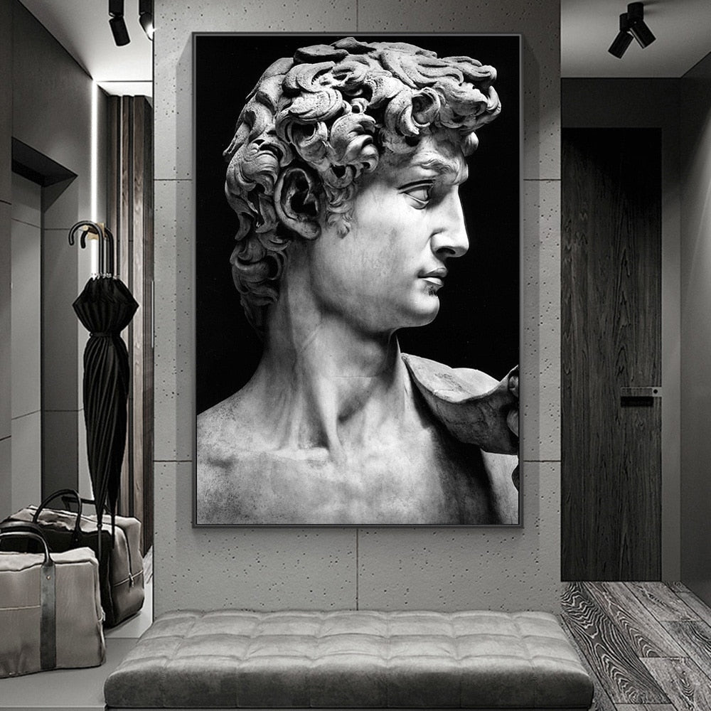 A canvas print of the Michelangelo David statue displayed in a room setting, predominantly in black and white.