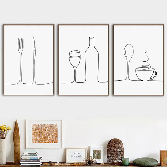 A set of three minimalist canvas prints depicting line art of a fork and knife, a wine glass, and a coffee cup, arranged on a wall.